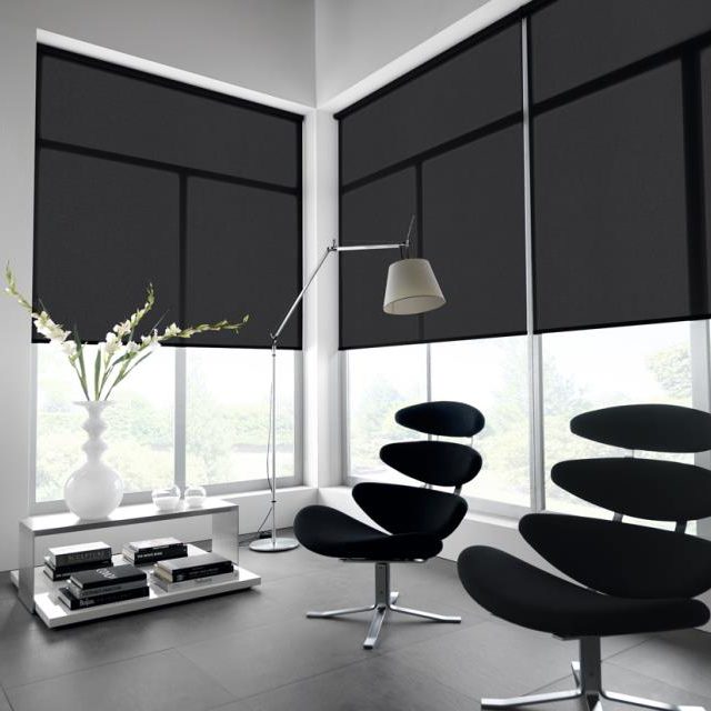 Black roller blinds in an office