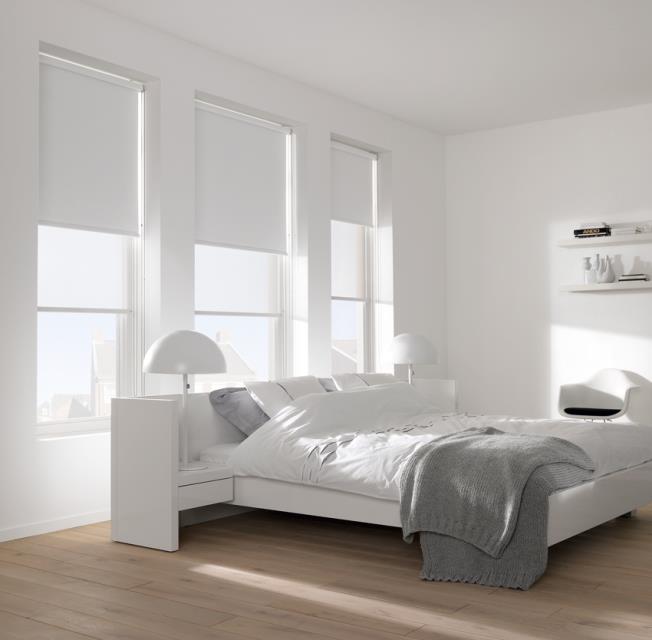 Roller blinds in a white bedroom