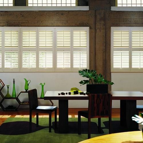 Timber shutters with green and black accessories