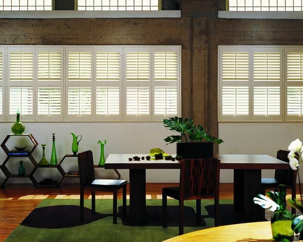 Timber shutters with green and black accessories
